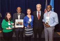 Dr. Thomson with awardees at a ceremony.